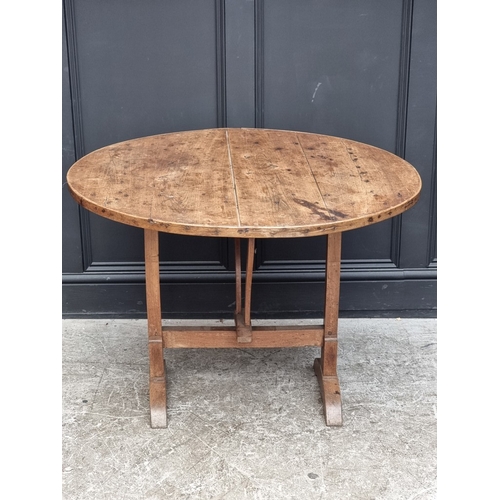 1012 - An 18th century French chestnut circular tilt-top vendage table, 96.5cm diameter.