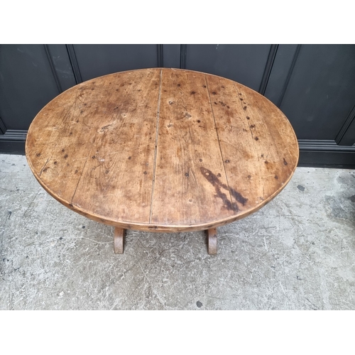 1012 - An 18th century French chestnut circular tilt-top vendage table, 96.5cm diameter.