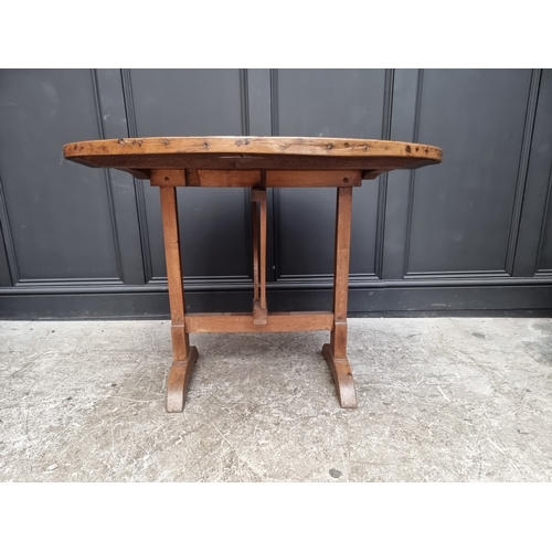 1012 - An 18th century French chestnut circular tilt-top vendage table, 96.5cm diameter.