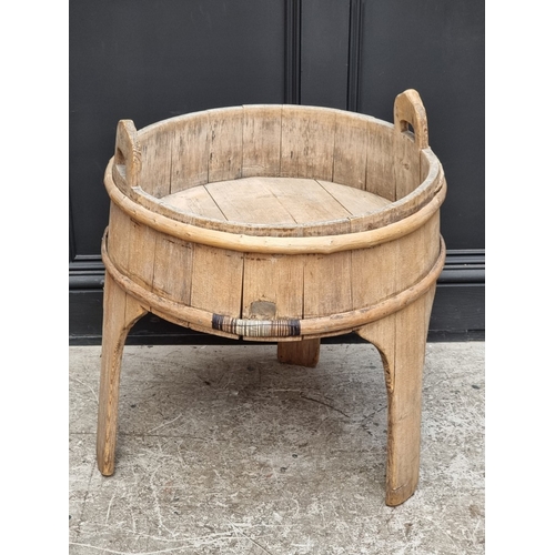 1020 - An antique Scandinavian staved pine twin handled tripod washing vessel, 59cm diameter.... 