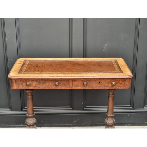 1040 - A Victorian walnut two drawer occasional table, with leather inset surface, (s.d.).