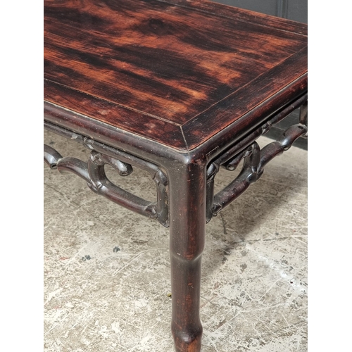 1042 - A late 19th century Chinese hardwood rectangular low occasional table, with simulated bamboo frieze,... 