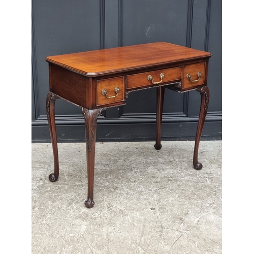 1043 - An early 20th century mahogany kneehole side table, on cabriole legs with scroll feet, 90cm wide.... 