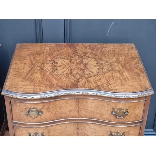 1051 - A pair of reproduction figured walnut serpentine fronted bedside chests, 52cm wide.