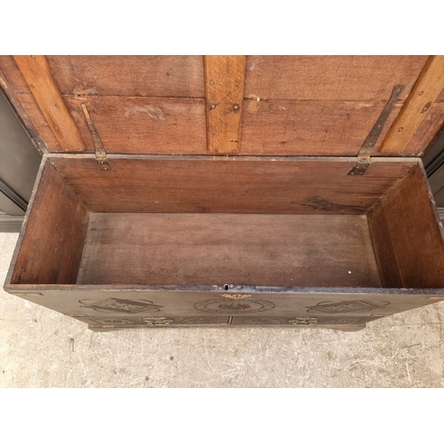 1054 - An 18th century carved oak mule chest, 118cm wide.