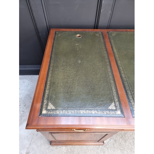 1057 - A large 'Reprodux' mahogany pedestal desk, by Bevan Funnel, 167.5cm wide.