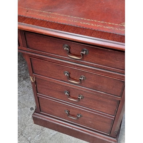 1058 - A large reproduction mahogany pedestal desk, by 'Norfolk Manor Furniture', 183.5cm wide.... 