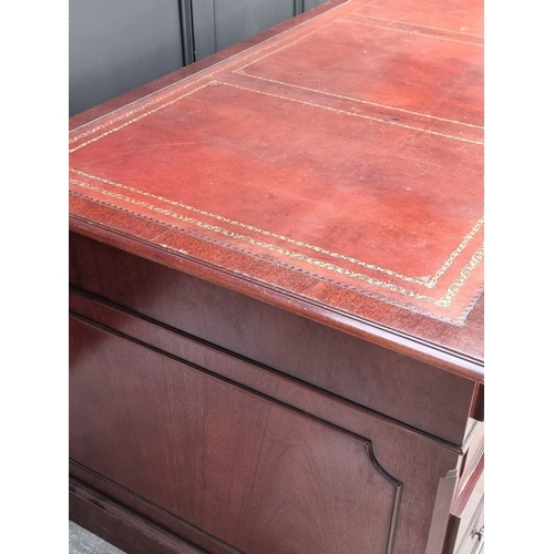 1058 - A large reproduction mahogany pedestal desk, by 'Norfolk Manor Furniture', 183.5cm wide.... 