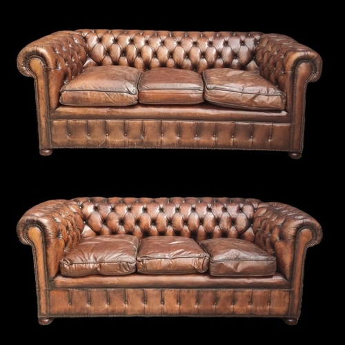 A good pair of buttoned brown leather Chesterfield settees, 200cm wide.