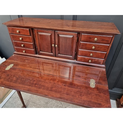 1004 - A reproduction mahogany bonheur du jour, with fold-over surface, 86cm wide.