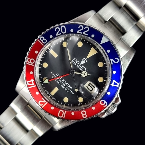 A circa 1969 Rolex 'GMT-Master Pepsi' stainless steel automatic wristwatch, 39mm x 12mm, Ref. 1675, Cal. 1570, the 'Mark II' matt black dial having open chapter ring and 'Tropical' indices, 'Non-Quickset' date model, the later crown measuring approximately 5.1mm, on stainless steel Rolex 'Oyster' bracelet; the end links stamped '93150', '580' and with an 'A' to the clasp, to include a secondary Rolex style 'Lunette Noir' bezel, complete with original 'Trapeze' box, wallets and pouch, papers to include: Chronometer guarantee; purchase receipt; service receipts; together with a small group of vintage COMEX (Compagnie Maritime d'Expertises) 'patches'. (Serviced in 1996 and 2018). 