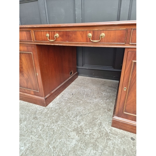 1047 - A large 'Reprodux' mahogany pedestal desk, by Bevan Funnel, 167.5cm wide.
