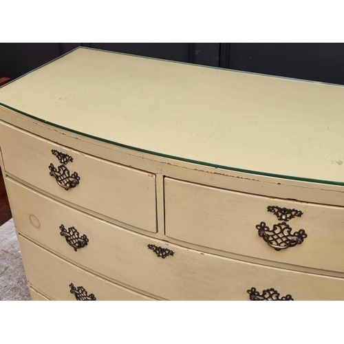 1003 - An old cream painted bowfront chest of drawers, 99.5cm wide.