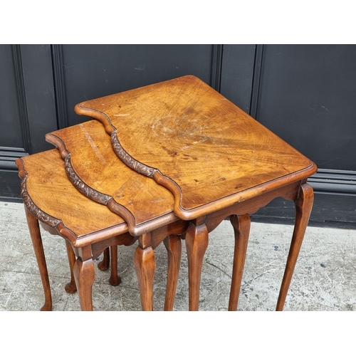 1011 - A nest of three 1930s walnut tables, largest 54cm wide.