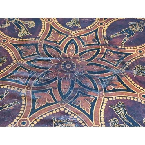 1016 - A 19th century ebonized octagonal tilt-top tripod table, with stencilled decoration, 48cm wide.... 