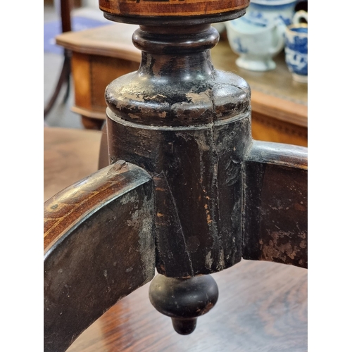 1016 - A 19th century ebonized octagonal tilt-top tripod table, with stencilled decoration, 48cm wide.... 