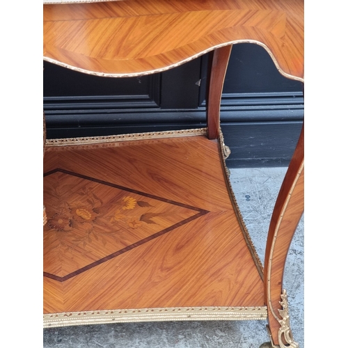 1019 - A Louis XV style tulipwood, marquetry and gilt brass trolley, 91cm wide.