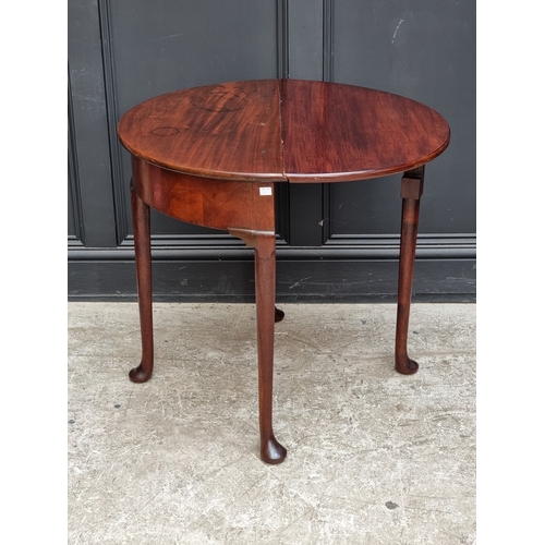 1020 - A mahogany demi-lune drop leaf table, with hinged top and single gateleg, 76cm wide.... 
