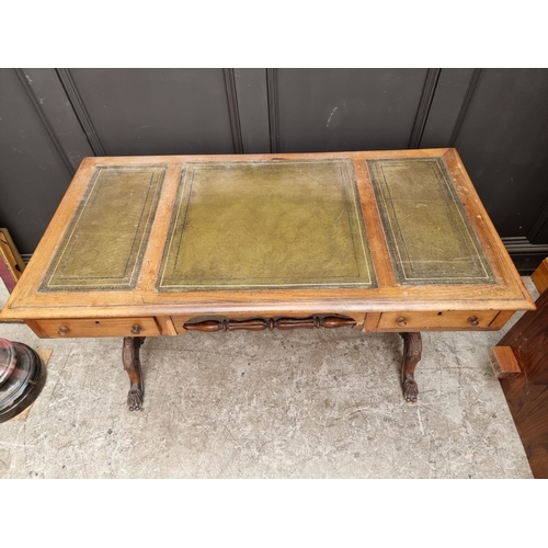 1028 - A Victorian rosewood desk, on reeded turned supports and joined by a central stretcher, 121cm wide, ... 