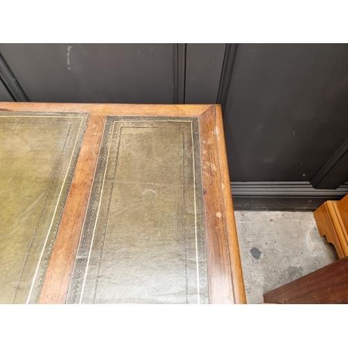 1028 - A Victorian rosewood desk, on reeded turned supports and joined by a central stretcher, 121cm wide, ... 