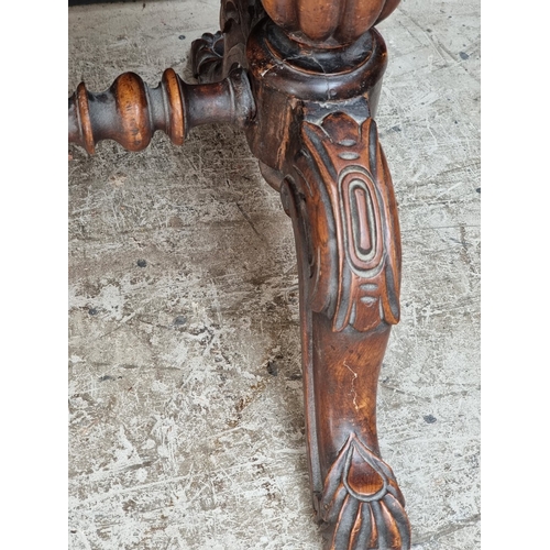 1028 - A Victorian rosewood desk, on reeded turned supports and joined by a central stretcher, 121cm wide, ... 