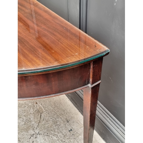 1029 - A 19th century mahogany single drawer demi-lune console table, 122cm wide.