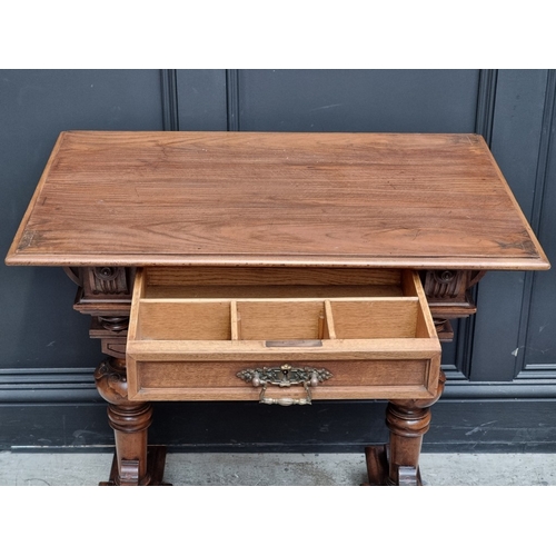 1038 - An unusual late 19th century French carved walnut occasional table,&nbsp;79cm wide.