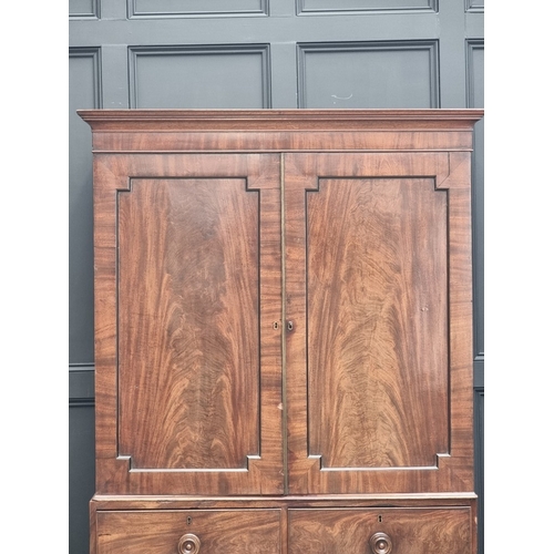 1048 - A George III mahogany linen press, now enclosing hanging space, 121cm wide.