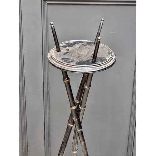 1050 - A pair of ebonized simulated bamboo tripod torcheres, 116cm high.&nbsp;