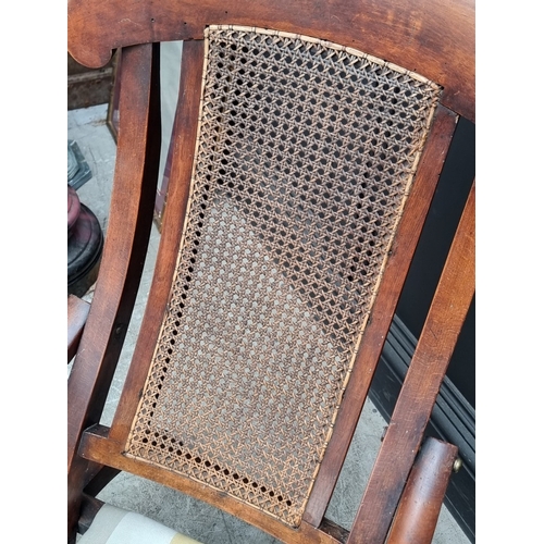 1055 - A late Victorian mahogany and beech folding steamer chair, with cane back.