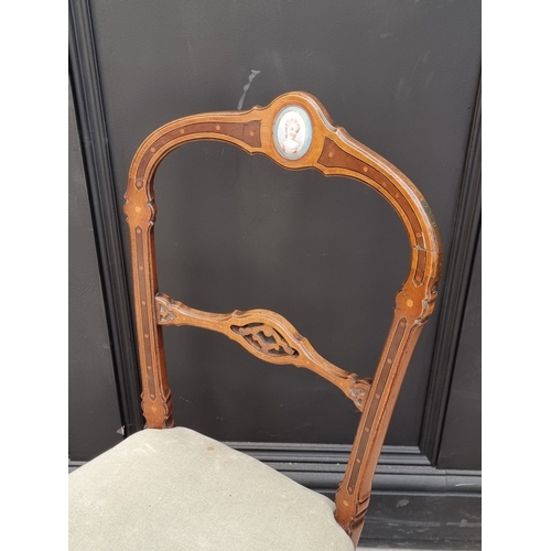 1058 - A pair of late 19th century French walnut and inlaid salon chairs, incorporating Sevres style porcel... 