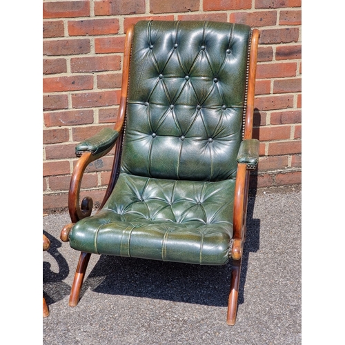 1056 - A pair of mahogany and buttoned green leather slipper chairs.