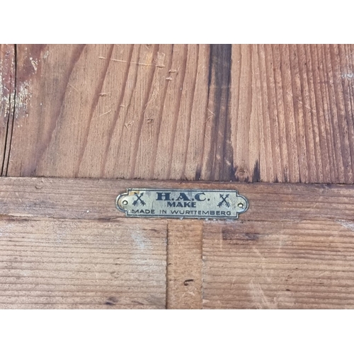 41 - A small early 20th century Continental wall clock, the 8in dial inscribed 'Lodge Plugs Sold Here', w... 