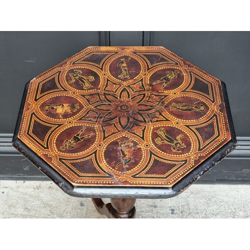 1019 - A 19th century ebonized octagonal tilt-top tripod table, with stencilled decoration, 48cm wide.... 