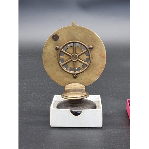 12 - A vintage brass and enamel RAC car radiator badge, No.B14517, with cap, 14.5cm high; together with a... 