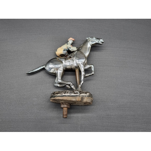15 - A vintage chrome plated Horse & Jockey car mascot, with painted decoration, the edge of the base... 