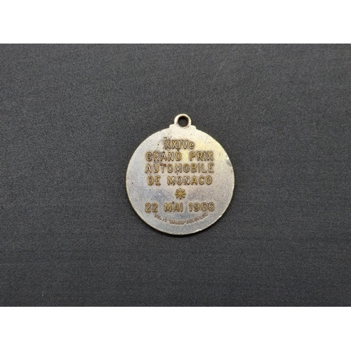 24 - A 1966 Monaco Grand Prix medal, inscribed verso, 3.4cm diameter.