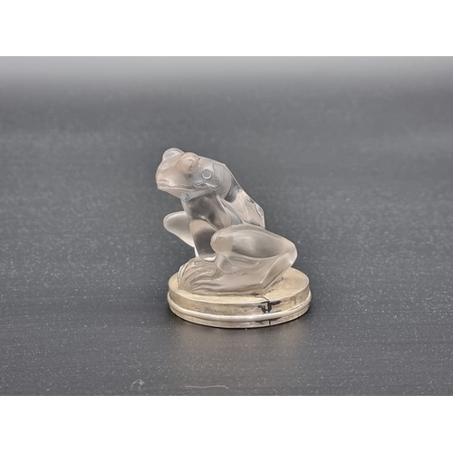 6 - A Rene Lalique 'Grenouille' clear glass car mascot, the base enclosed within a silver mount, 6cm hig... 