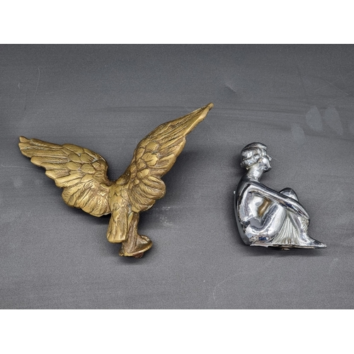 21 - A vintage brass Eagle car mascot, wingspan 20cm; together with another chrome plated seated lady exa... 