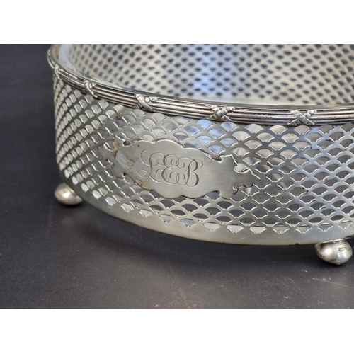 209 - A white metal swing handled basket, with glass liner, stamped 'Sterling', 17cm diameter.... 