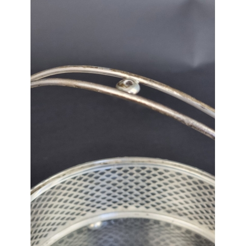 209 - A white metal swing handled basket, with glass liner, stamped 'Sterling', 17cm diameter.... 