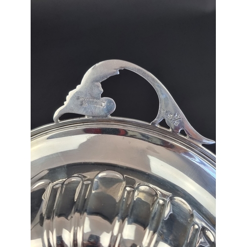 217 - A white metal twin handled bowl, stamped 'Sterling', 23cm wide.