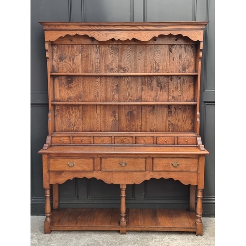 1000 - A good reproduction oak potboard dresser and rack, 152.5cm wide.