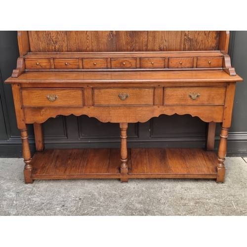 1000 - A good reproduction oak potboard dresser and rack, 152.5cm wide.