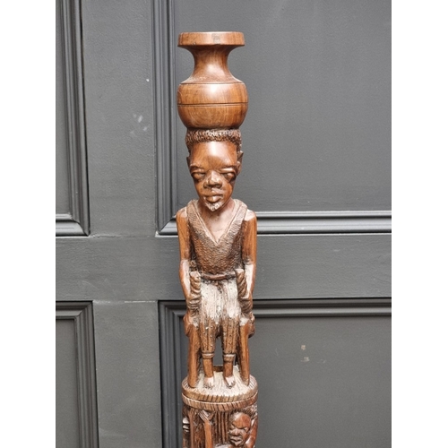 1003 - Ethnographica: a carved hardwood standard lamp, 155cm high.