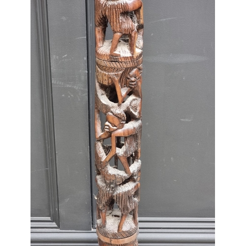 1003 - Ethnographica: a carved hardwood standard lamp, 155cm high.