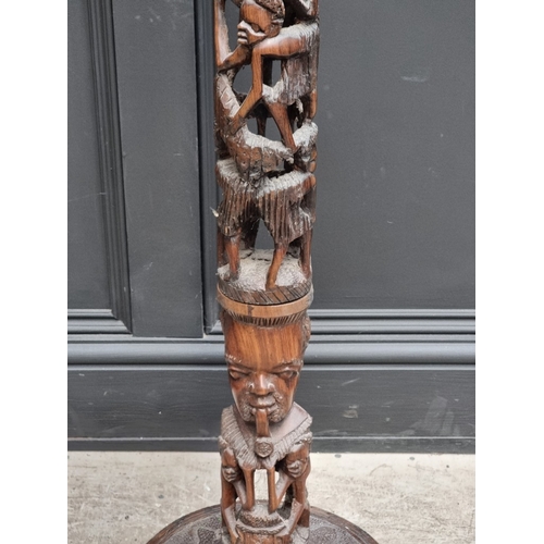 1003 - Ethnographica: a carved hardwood standard lamp, 155cm high.