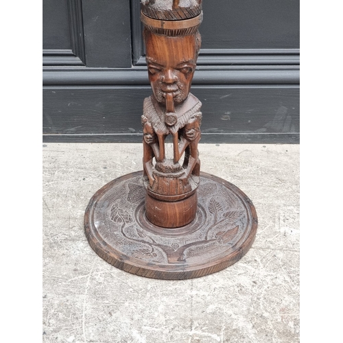 1003 - Ethnographica: a carved hardwood standard lamp, 155cm high.
