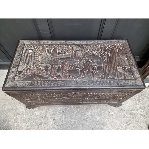 1005 - A Chinese carved camphor wood coffer, 106.5cm wide.