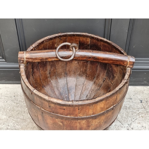 1007 - A large Chinese staved pine pail, on tripod stand, total height 58cm.